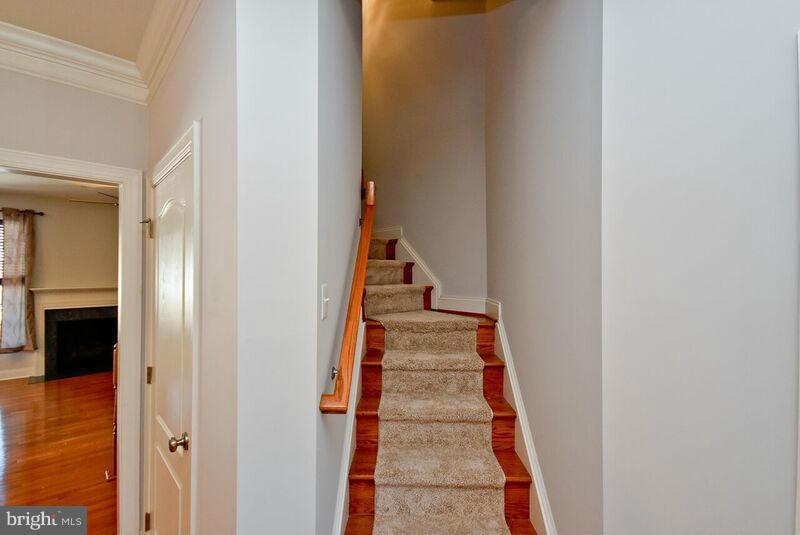 7616 Elmcrest Road Hanover, MD 21076 - Photo 12 of 30 a hallway with front door windows and stairs