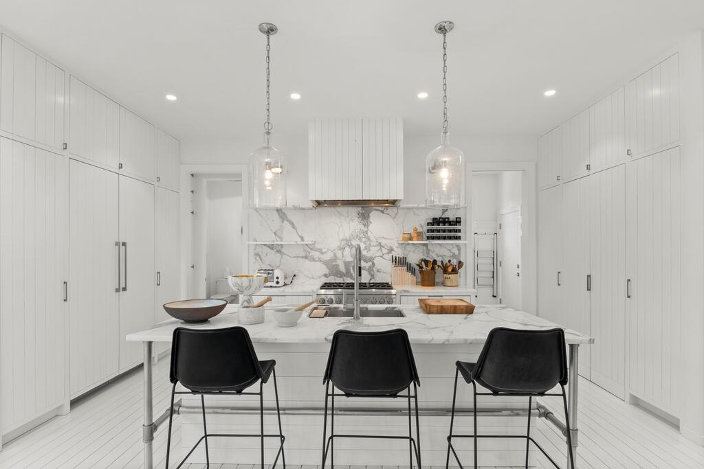 17 Meridian Road Rowayton, CT 06853 - Photo 7 of 40 a kitchen with stainless steel appliances kitchen island granite countertop a table and chairs