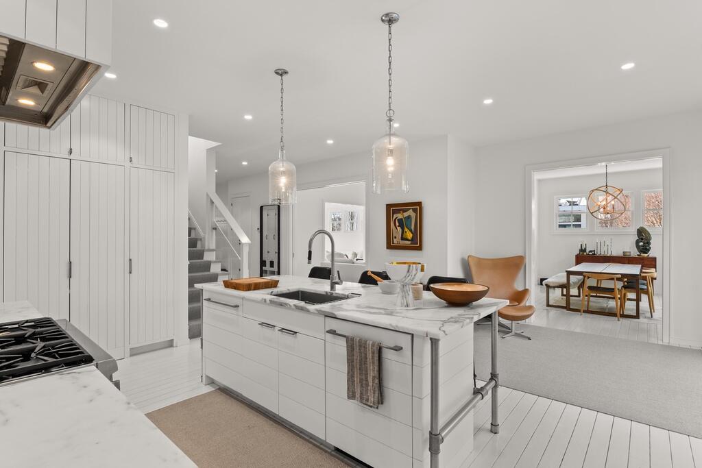 17 Meridian Road Rowayton, CT 06853 - Photo 10 of 40 a kitchen that has a sink a stove and chairs in it