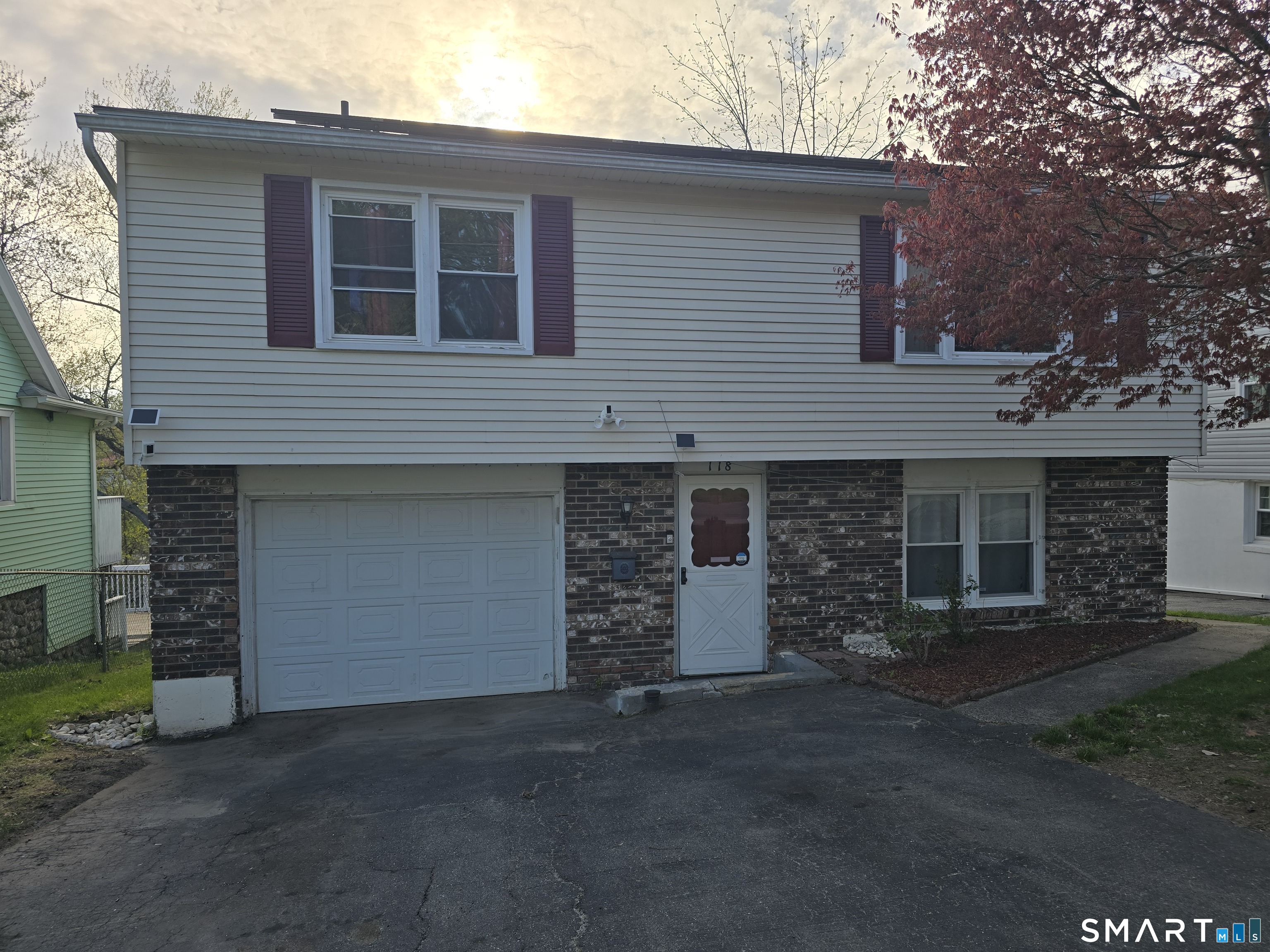 118 Norton Street Waterbury, CT 06708 - Photo 2 of 12 a front view of a house with a yard and garage