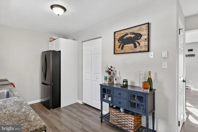 a view of a workspace with furniture and wooden floor
