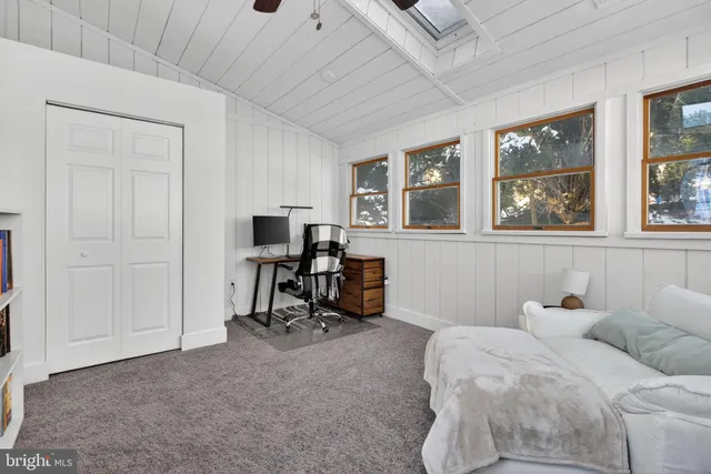 a bedroom with furniture and a window