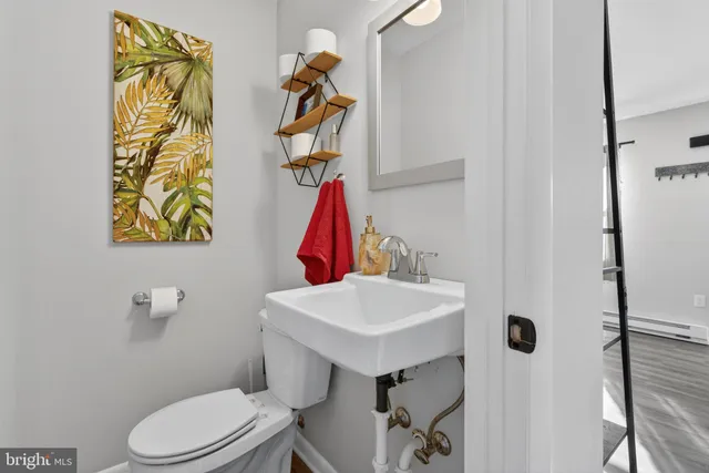 a bathroom with a sink toilet and mirror