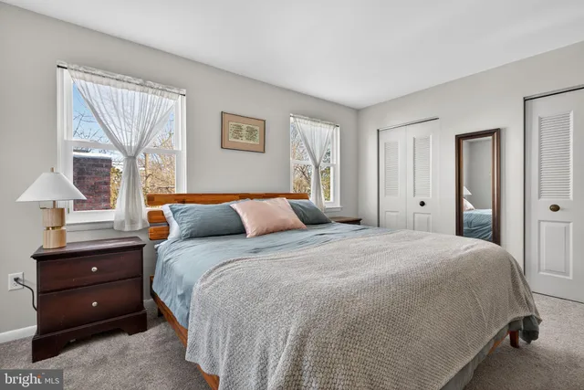 a bedroom with a bed and a night stand