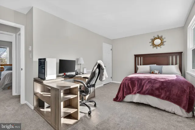 a bedroom with a bed and a desk
