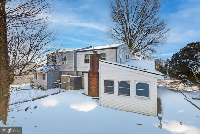 a view of a house with a yard covered in snow