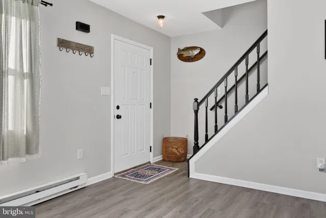a view of an entryway with wooden floor
