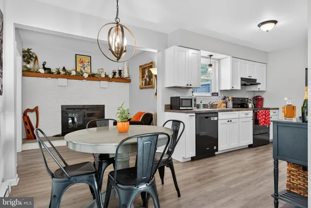 a dining room with furniture a rug and a fireplace