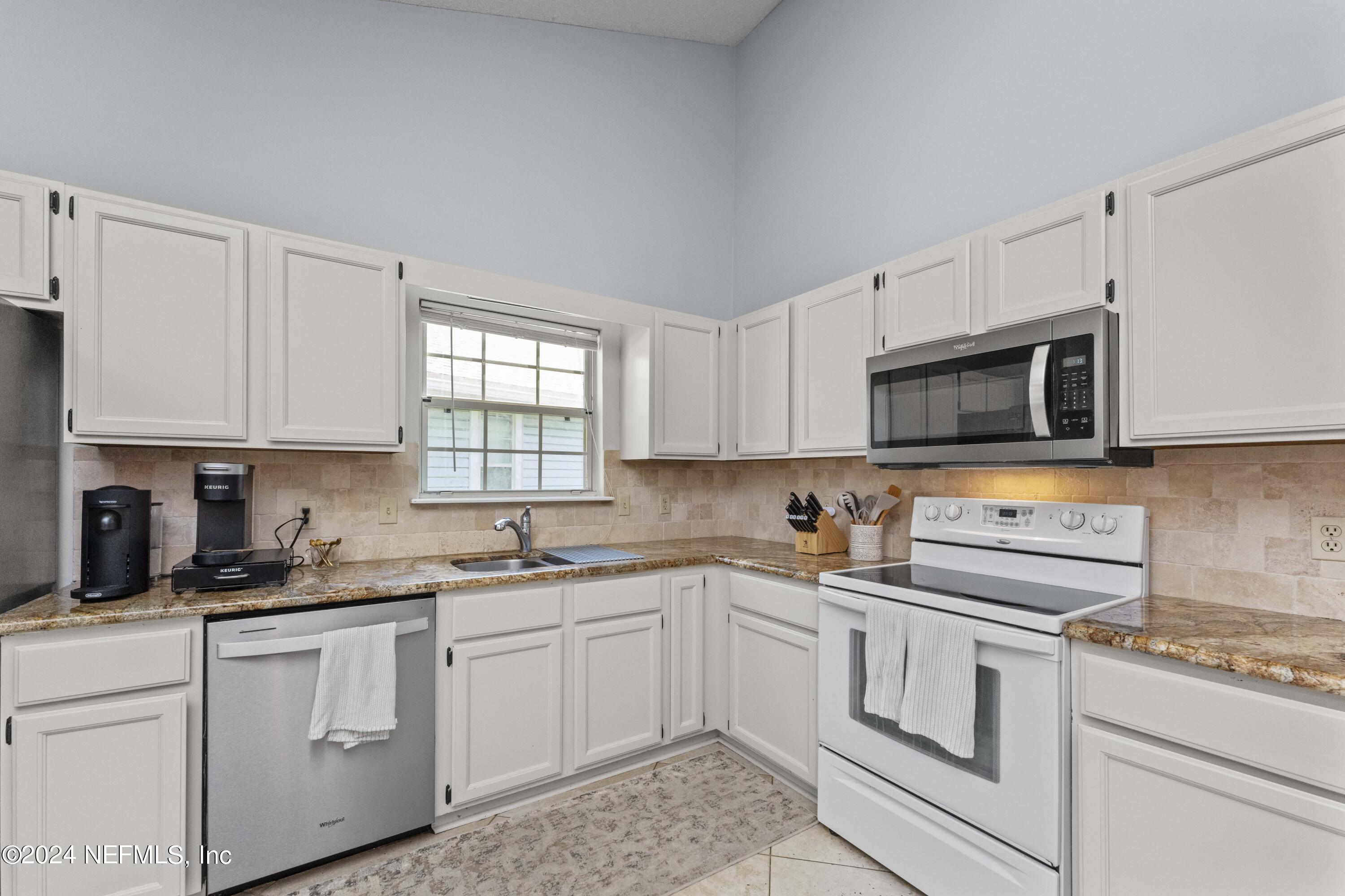 8808 Goodbys Trace Drive Jacksonville, FL 32217 - Photo 11 of 25 a kitchen with white cabinets stainless steel appliances and sink