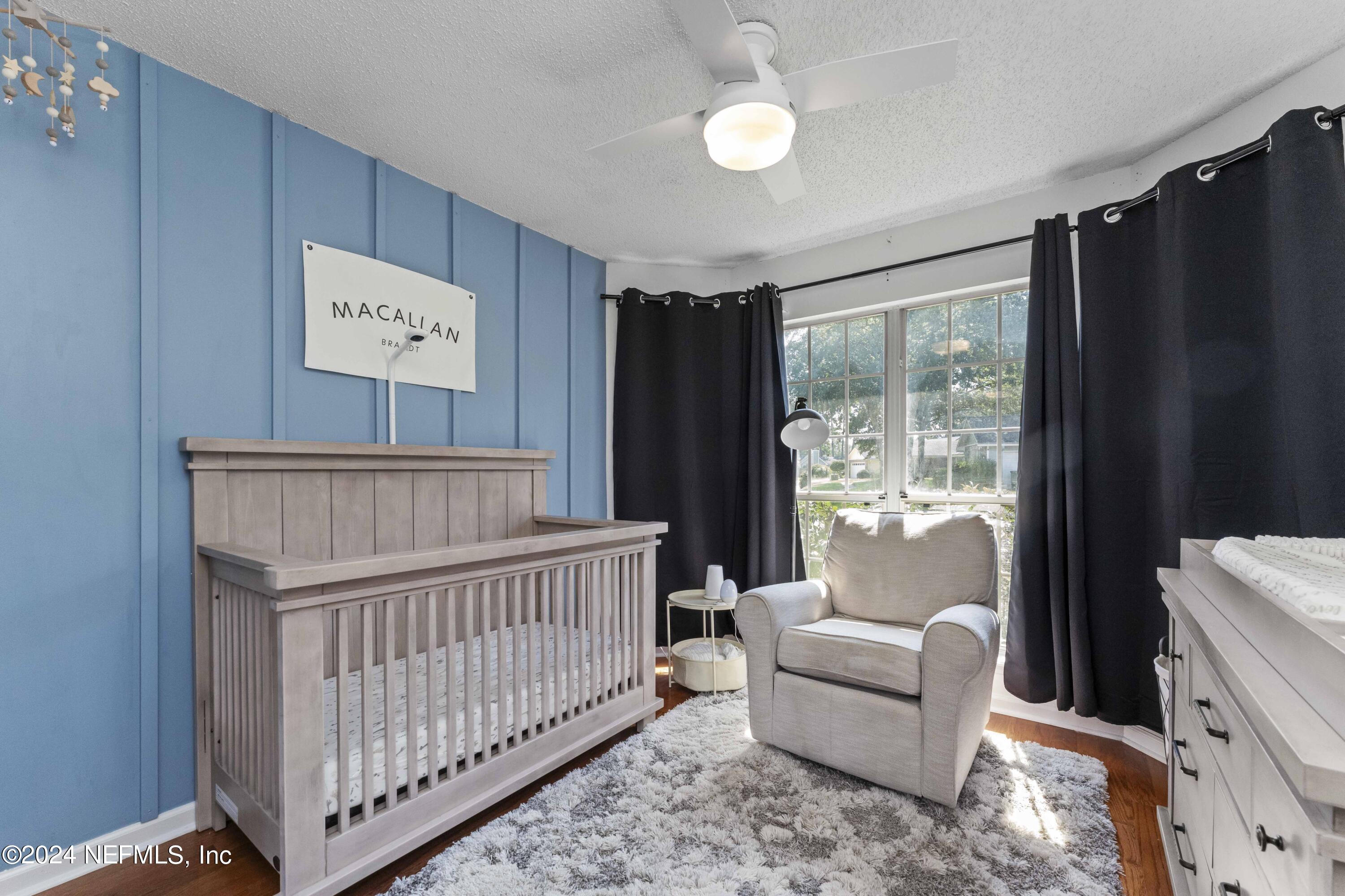 8808 Goodbys Trace Drive Jacksonville, FL 32217 - Photo 18 of 25 a bedroom with furniture and a window