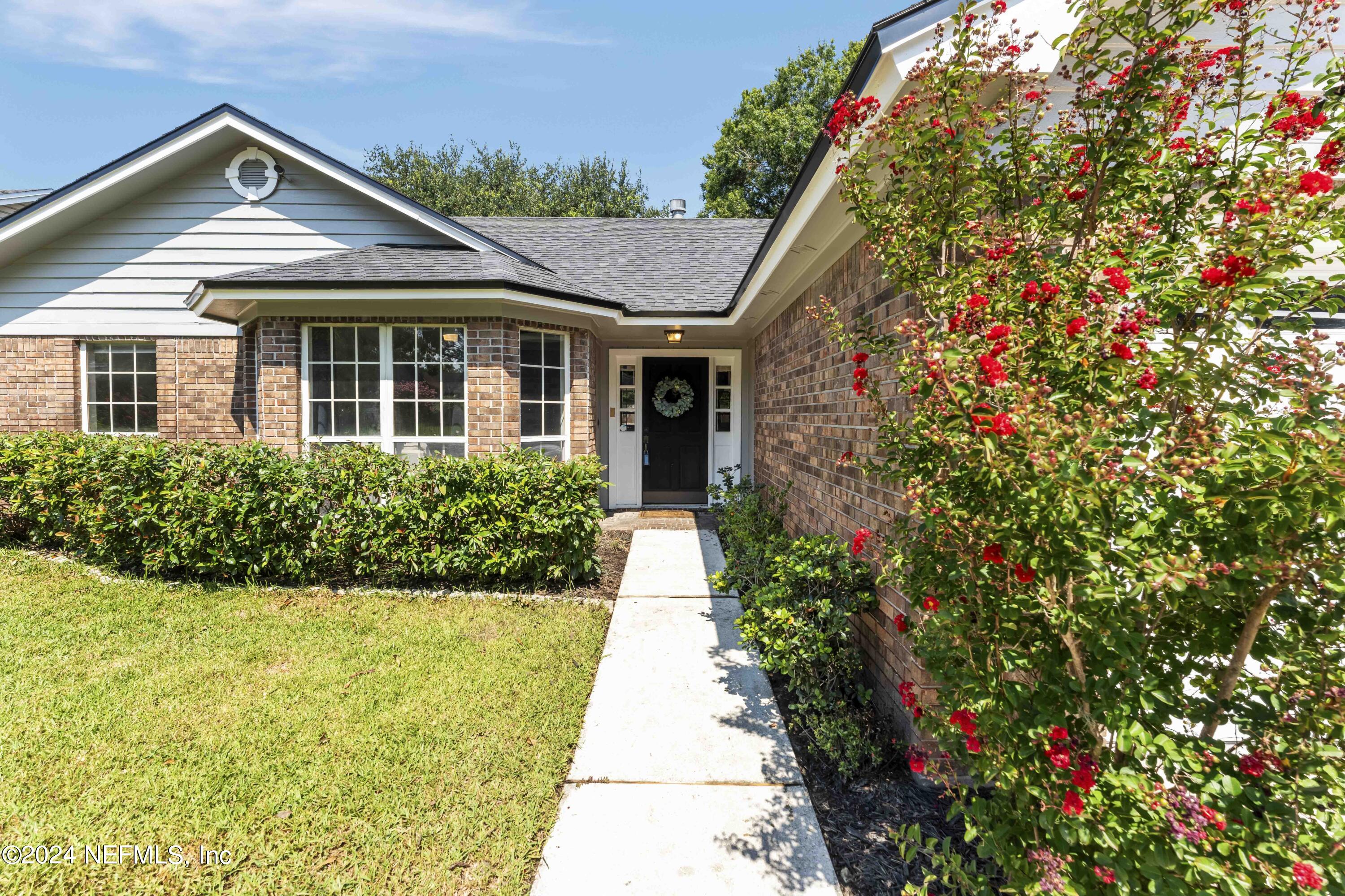 8808 Goodbys Trace Drive Jacksonville, FL 32217 - Photo 2 of 25 a front view of a house with a yard and potted plants