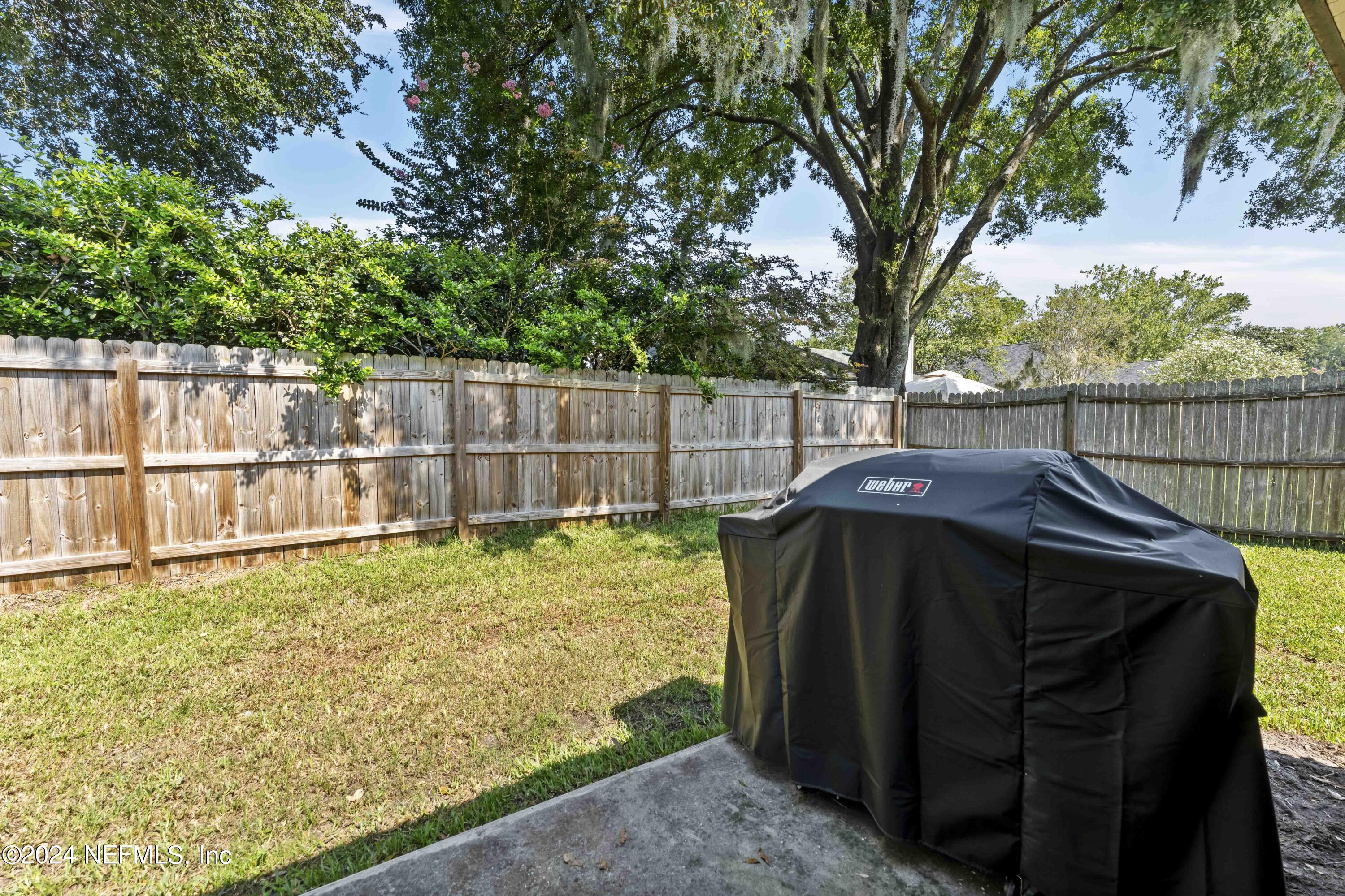 8808 Goodbys Trace Drive Jacksonville, FL 32217 - Photo 21 of 25 a view of a deck with a small yard and wooden fence