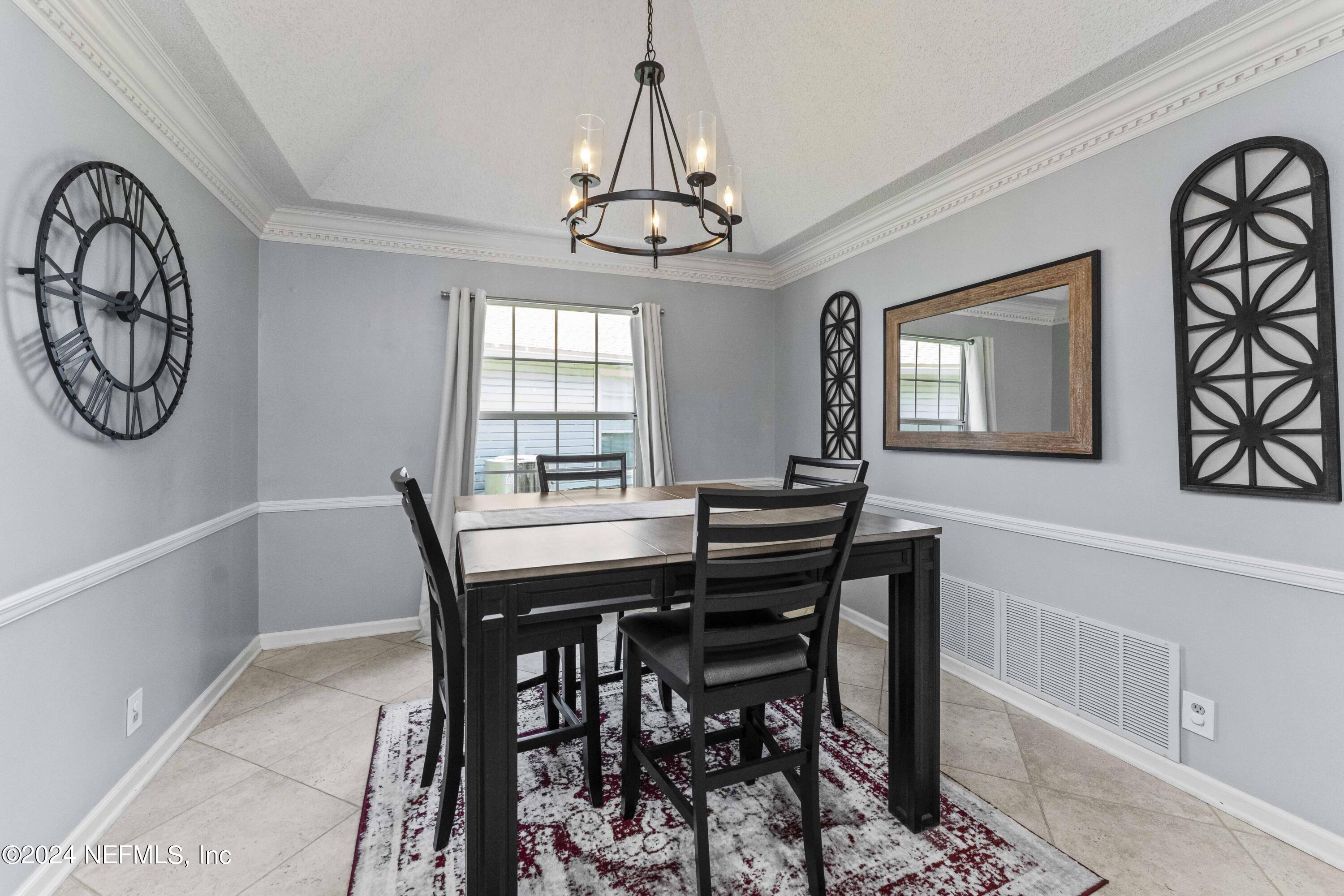 8808 Goodbys Trace Drive Jacksonville, FL 32217 - Photo 7 of 25 a view of a dining room with furniture and a chandelier