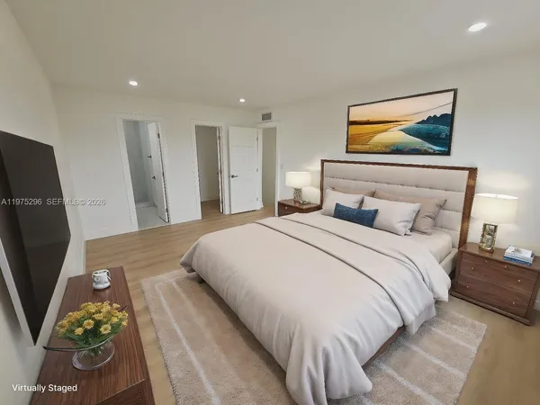 a bedroom with a bed and a flat screen tv