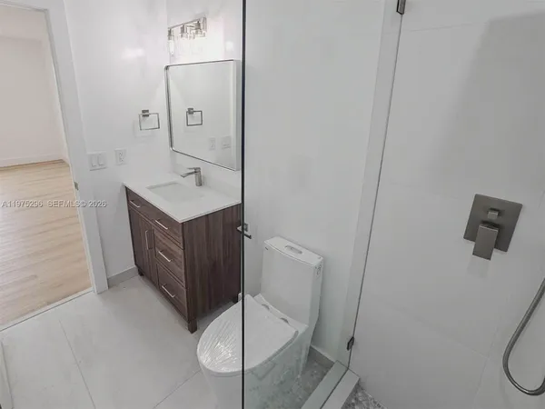 a bathroom with a sink a mirror and a shower