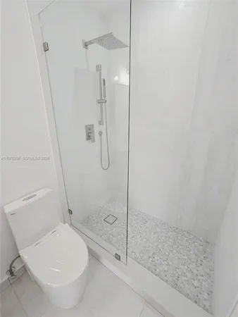 a bathroom with a toilet and a shower