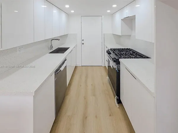 a kitchen with counter top space and appliances