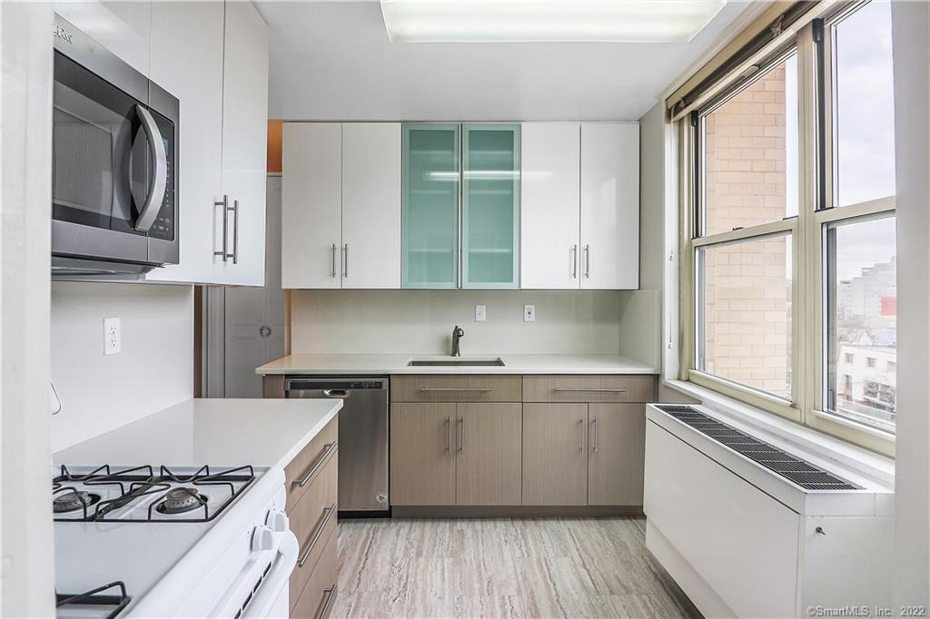 50 Glenbrook Road, Unit 4G Stamford, CT 06902 - Photo 1 of 1 Newly renovated with quartz countertops, backsplash, cabinets, stainless steel refrigerator, dishwasher, and microwave, and laminate flooring.