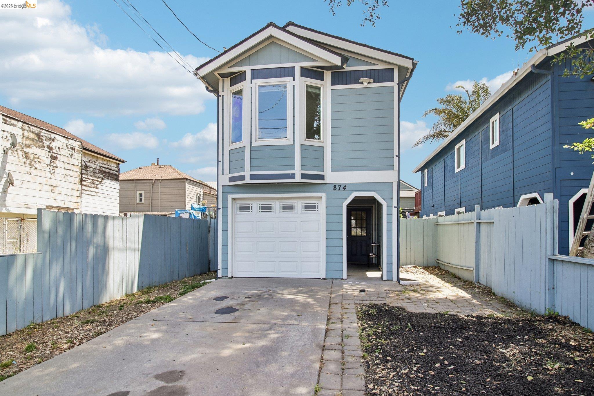 874 Pine Street Oakland, CA 94607 - Photo 1 of 39 Two-story residence featuring a light blue exterior with white trim