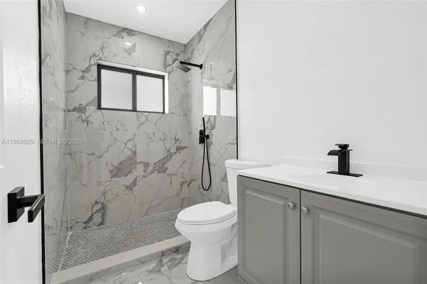 a kitchen with stainless steel appliances granite countertop a sink a stove and a wooden floors