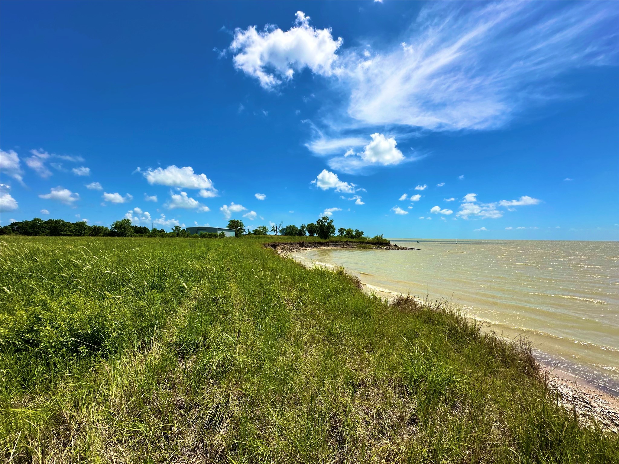 2101 West Bayshore Road Anahuac, TX 77514 - Photo 2 of 10 a view of an ocean and a yard