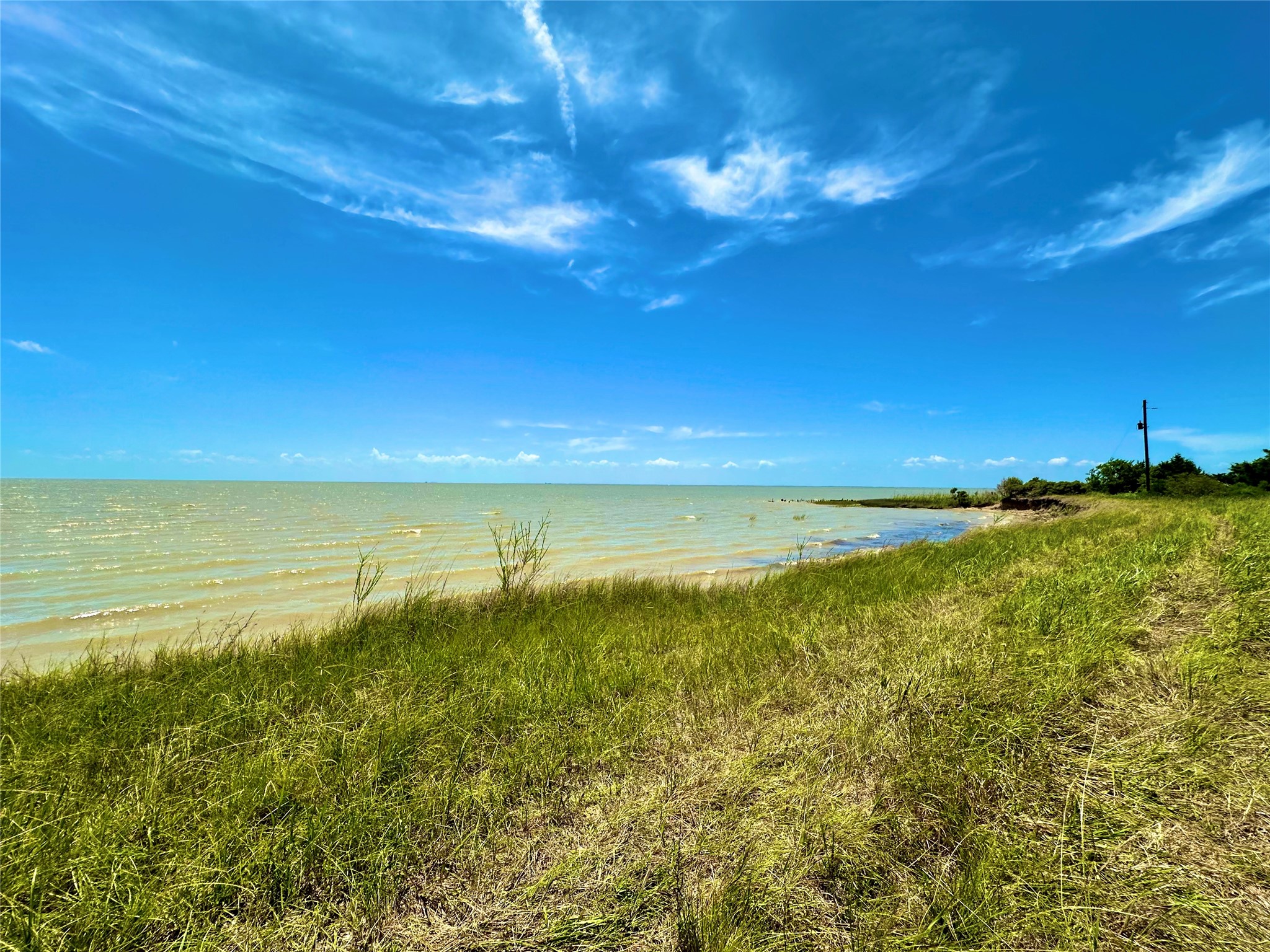 2101 West Bayshore Road Anahuac, TX 77514 - Photo 5 of 10 a view of an ocean from a yard