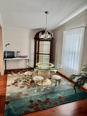 a room with kitchen island stainless steel appliances a stove a sink and a chandelier