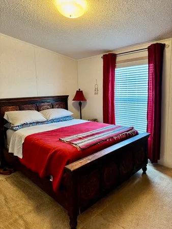 a bed sitting in a bedroom next to a window