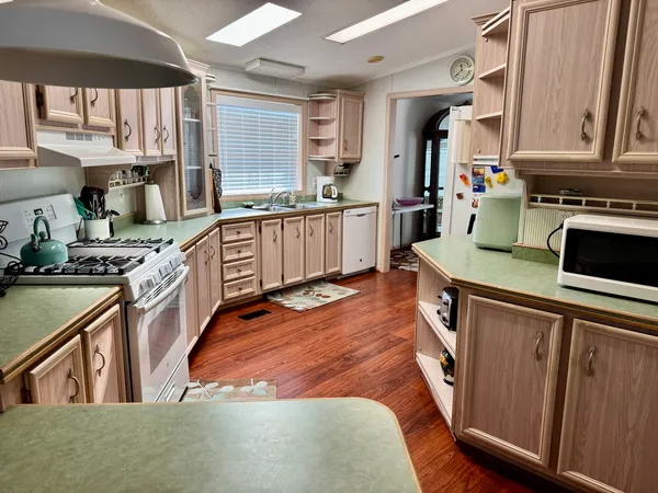 a kitchen with stainless steel appliances granite countertop a stove and a sink