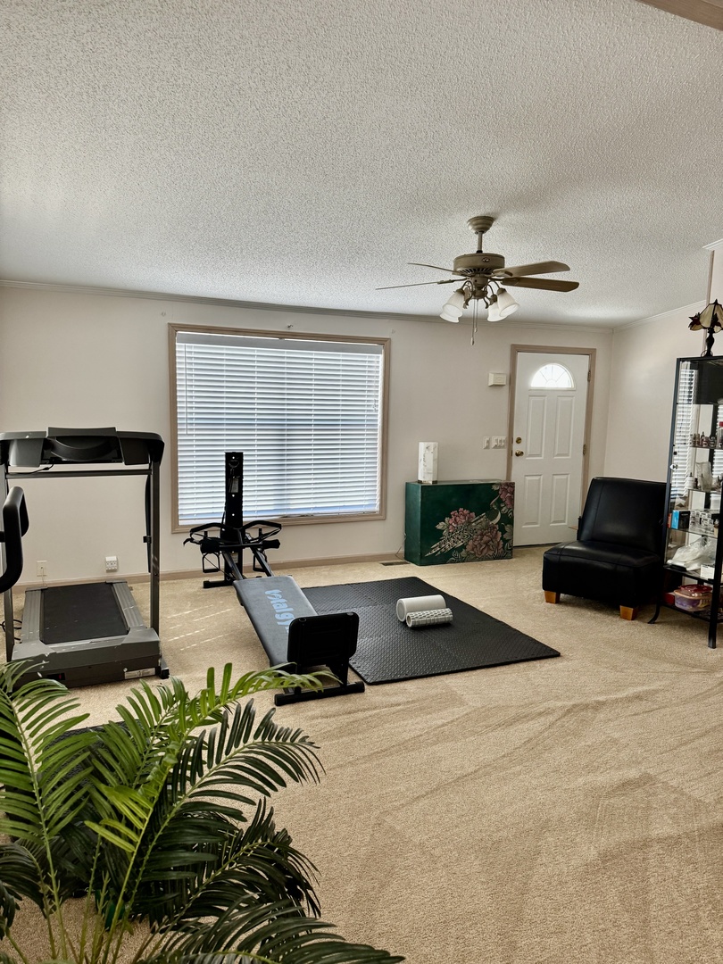 265 Tulip Circle Matteson, IL 60443 - Photo 8 of 25 a living room with furniture a large window and a chandelier