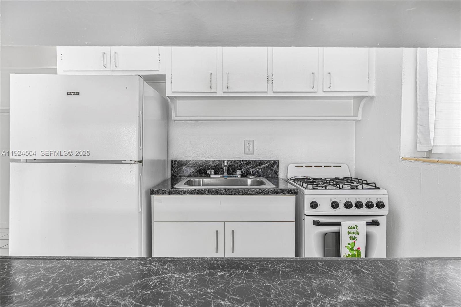 1850 Meridian Avenue, Unit 12 Miami Beach, FL 33139 - Photo 2 of 20 a white stove top oven sitting inside of a kitchen