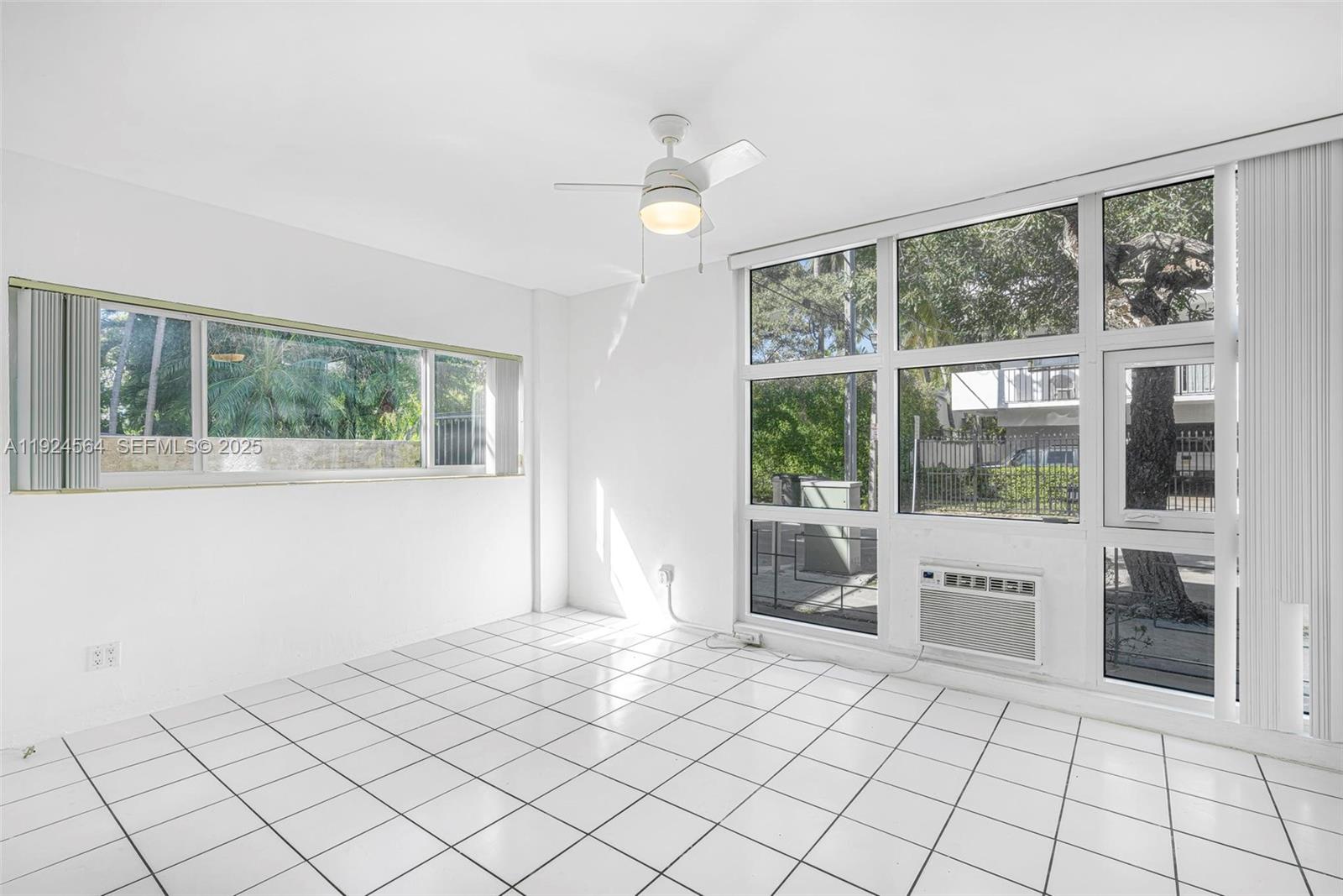 1850 Meridian Avenue, Unit 12 Miami Beach, FL 33139 - Photo 6 of 20 a view of an empty room with window and chandelier