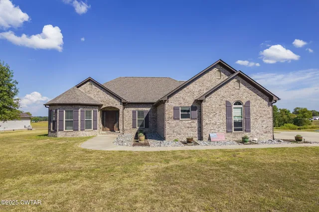 a view of a house with yard and sitting area