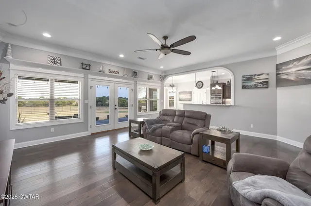 a living room with furniture and wooden floor