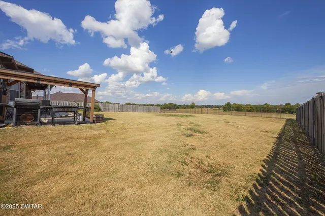 an aerial view of residential houses with outdoor space and lake view