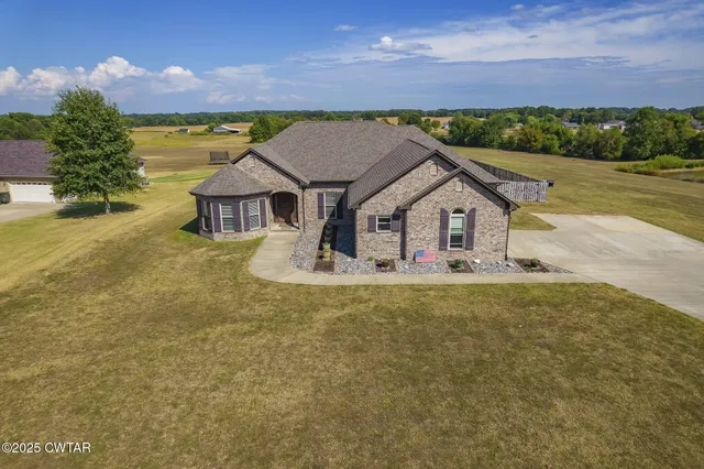 a aerial view of a house with a yard
