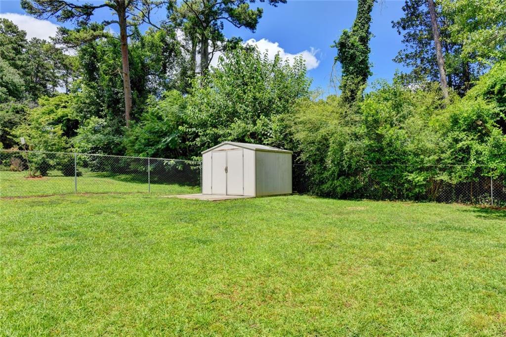 1577 Harbour Oaks Road Tucker, GA 30084 - Photo 58 of 58 a backyard of a house with lots of green space
