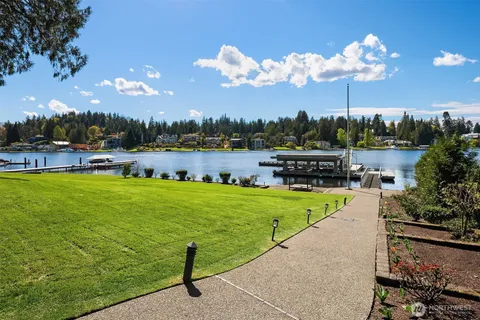 a view of a lake with a garden and swimming pool