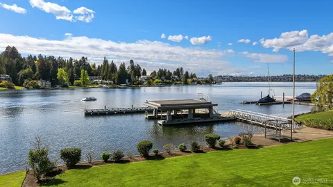 a view of a lake with lawn chairs