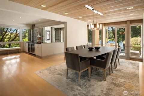 a dining room with furniture window and wooden floor