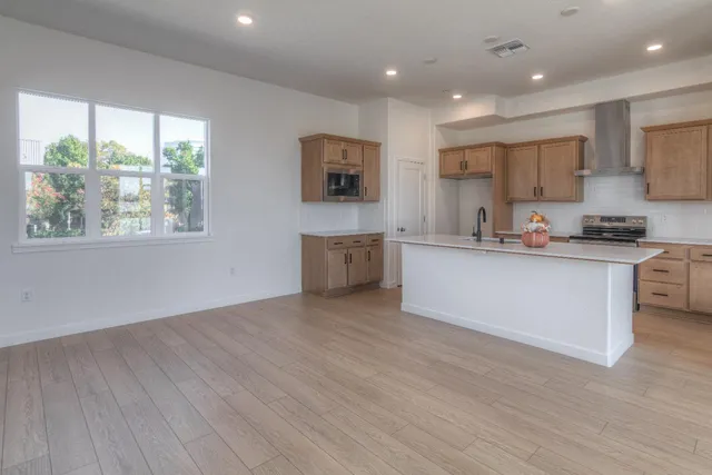 an empty room with windows and entrance to other room