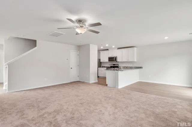 a view of kitchen with cabinet and refrigerator