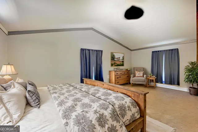 a spacious bathroom with a granite countertop sink toilet and shower