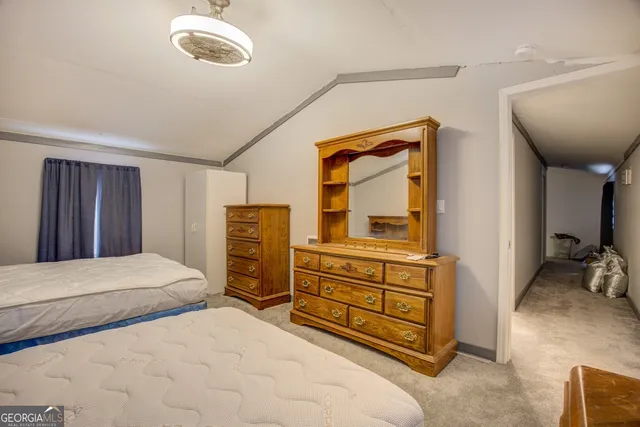 a view of outdoor space with wooden fence and trees