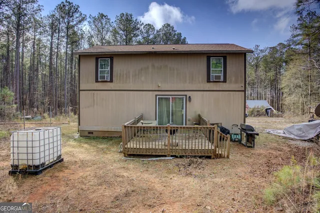 a view of a chair and table in backyard of the house