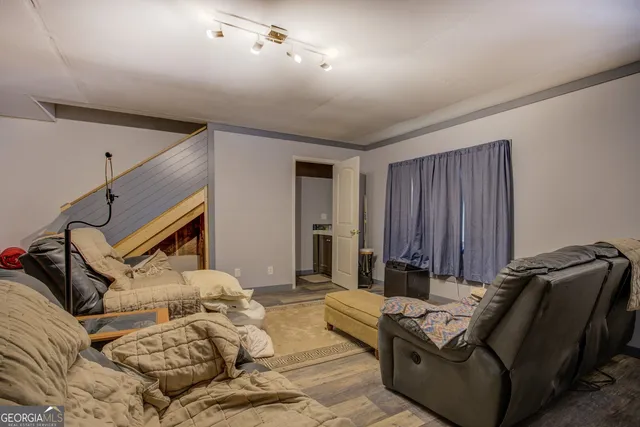a view of a workspace with furniture and a window