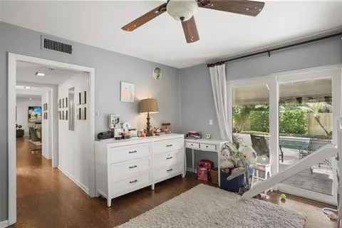a view of a bedroom with furniture window and wooden floor