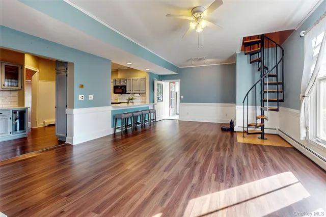 a view of livingroom with hardwood floor and a ceiling fan