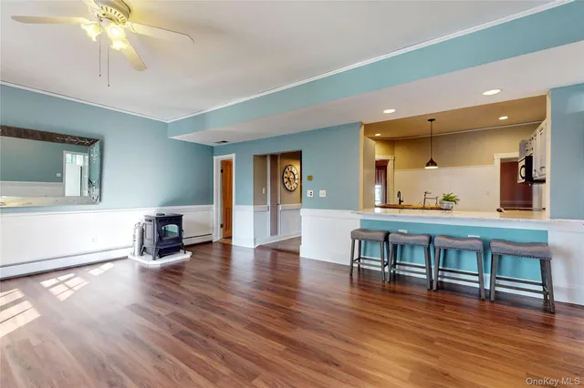 a view of a livingroom with furniture wooden floor and front door