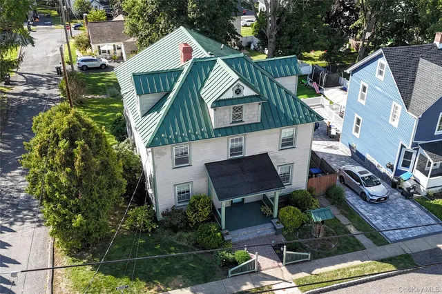 an aerial view of a house with a yard